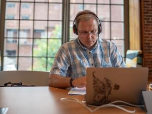 student on laptop with headphones